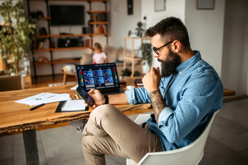 man looking at his stock investments on smart phone.