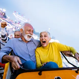 Senior man and woman on a roller coaster
